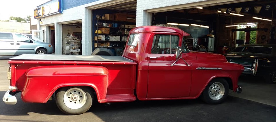 Classic red truck at service bay